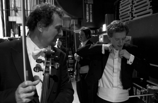 Before stepping out on the platform, Josef Špaček Sr. is checking whether his eponymous son, the leader of the Czech Philharmonic, has tied his bow tie correctly.