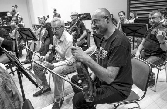 The orchestra members listen to the instructions given by Chief Conductor Jiří Bělohlávek before one of the eight Japanese concerts.